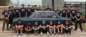 Jesuit wrestlers take a picture with the customized BMW to be auctioned for the benefit of Jesuit programs: jesuitcp.org