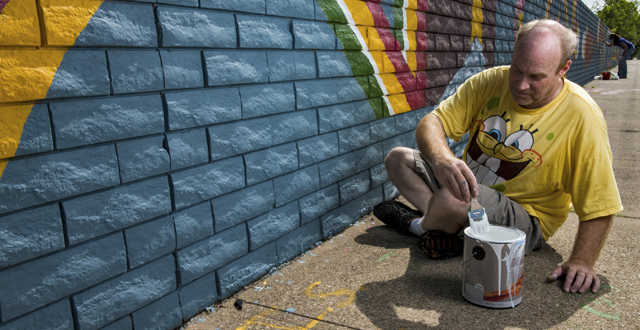 Brent Herling led volunteers in painting the Forest Lane wall on Saturday mornings: Photo by Danny Fulgencio 