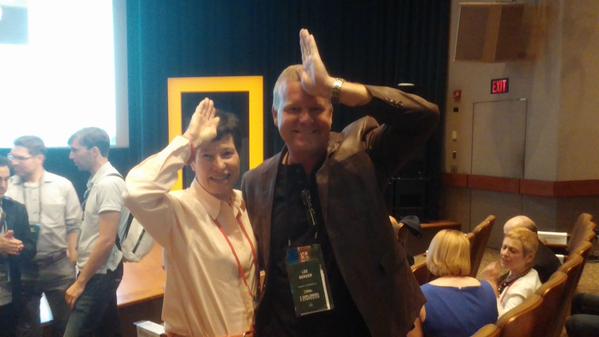 Hockaday grad Lyda Hill with paleoanthropologist Lee R. Berger via Twitter. They're imitating shark fins with their hands. 
