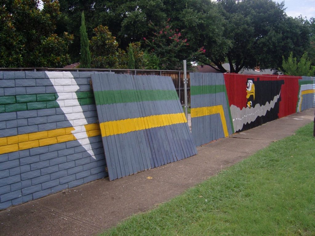 The wooden fence used to temporarily replace the mural on Forest Lane. (Photo from e-Bay)