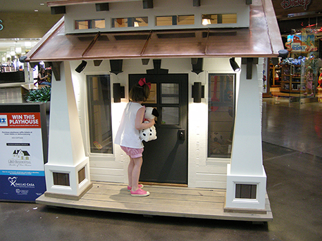 A child inspects one of the 15 offerings in CASA's 2016 Parade of Playhouses.