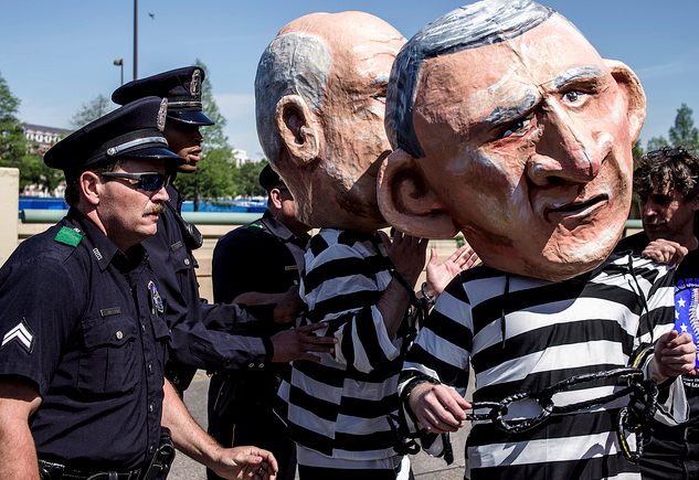 During the Bush Center opening, a scuffle ignited between protesters and police. Two men dressed in bobble-headed effigy as George W. Bush and Dick Cheney were subdued and cuffed. (Photo by Danny Fulgencio) 