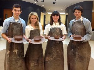 Episcopal students William Heidarian, Zoe Long, Kaki Miller, and Eric Stern pose with their bowls created for the Empty Bowls Project