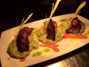 Pan seared diver scallops entree, served with house pork jowl and English pea risotto ($31)