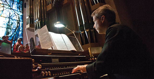 James Diaz, the director of music at St. Michael and All Angels Episcopal Church, plays the organ. Photo by Kim Leeson