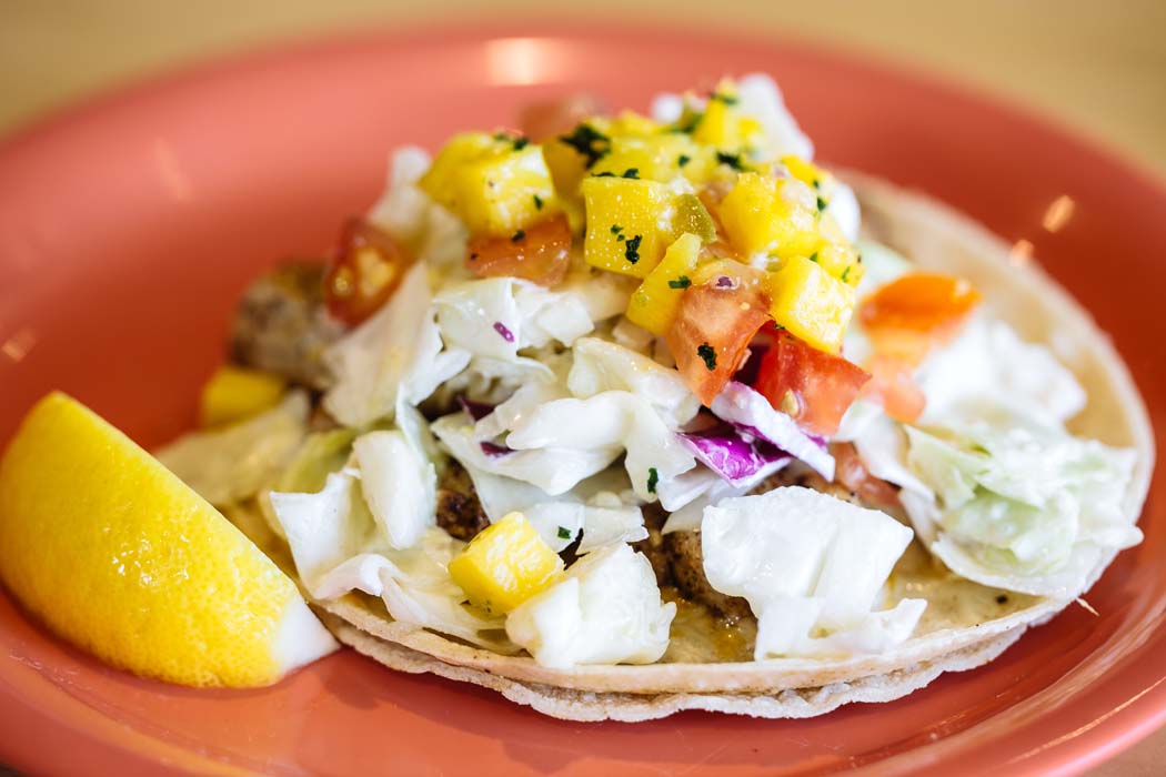 The restaurant is famous for its fish tacos topped with a heaping mound of coconut milk-based coleslaw and mango salsa. Photo by Kathy Tran