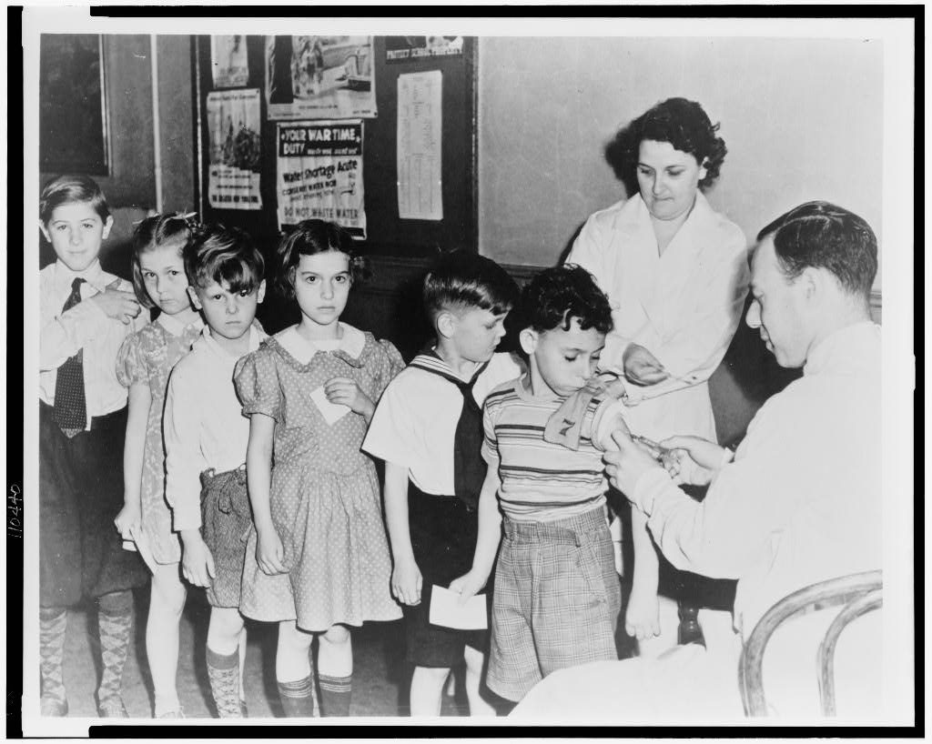 Schoolchildren wait in line for immunization shots at a child health station in New York City, N.Y., in 1944. (Photo courtesy of the Library of Congress)