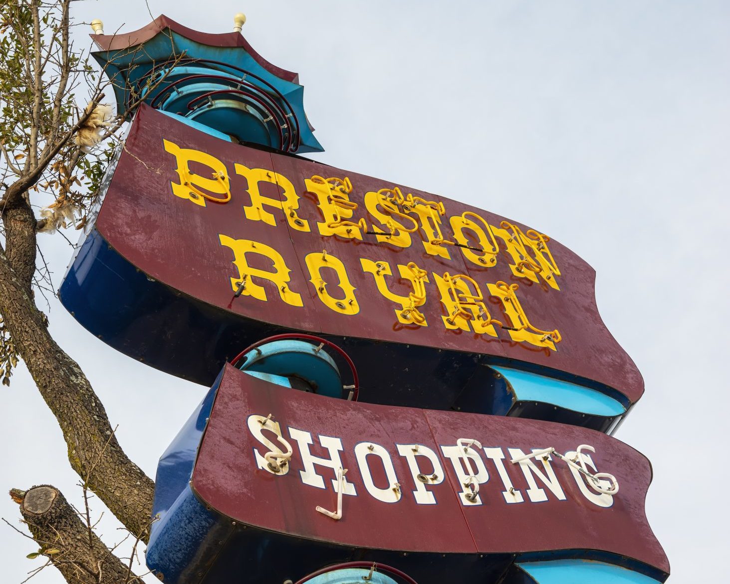 An old neon sign for the Preston Royal Shopping Center, which includes stores like Ken's Man's Shop.